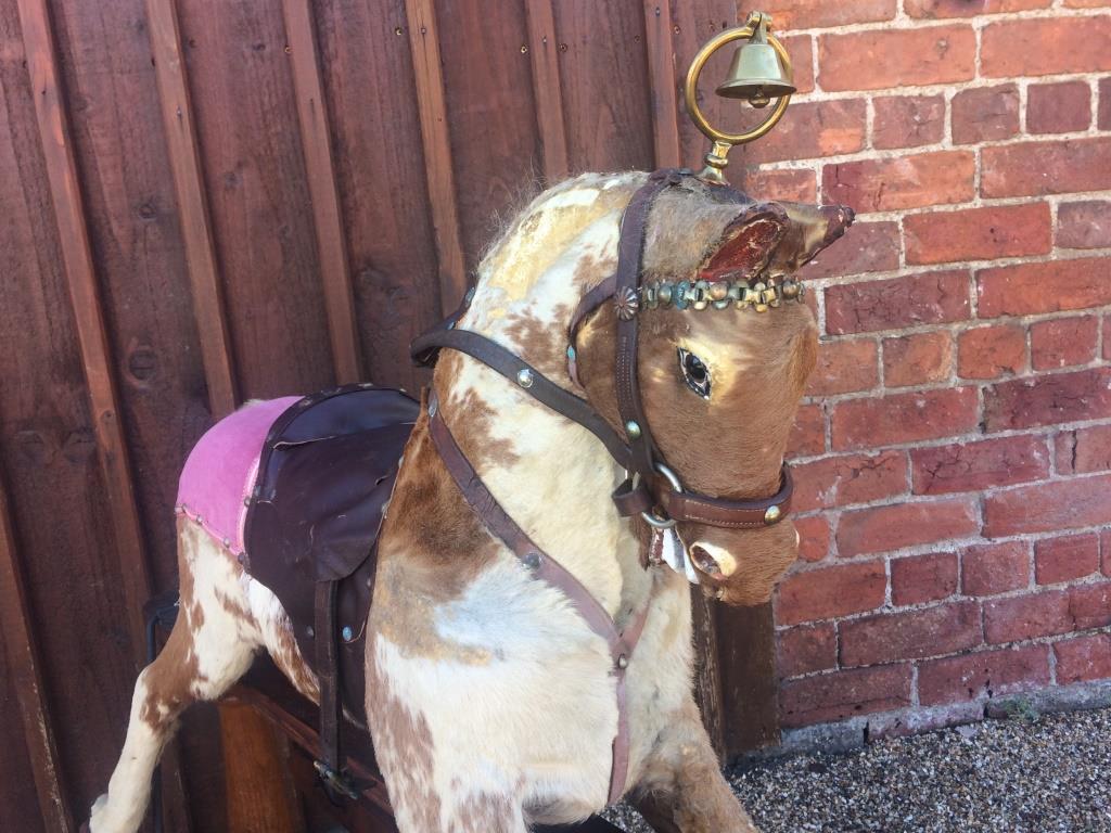 Hide covered antique rocking horse